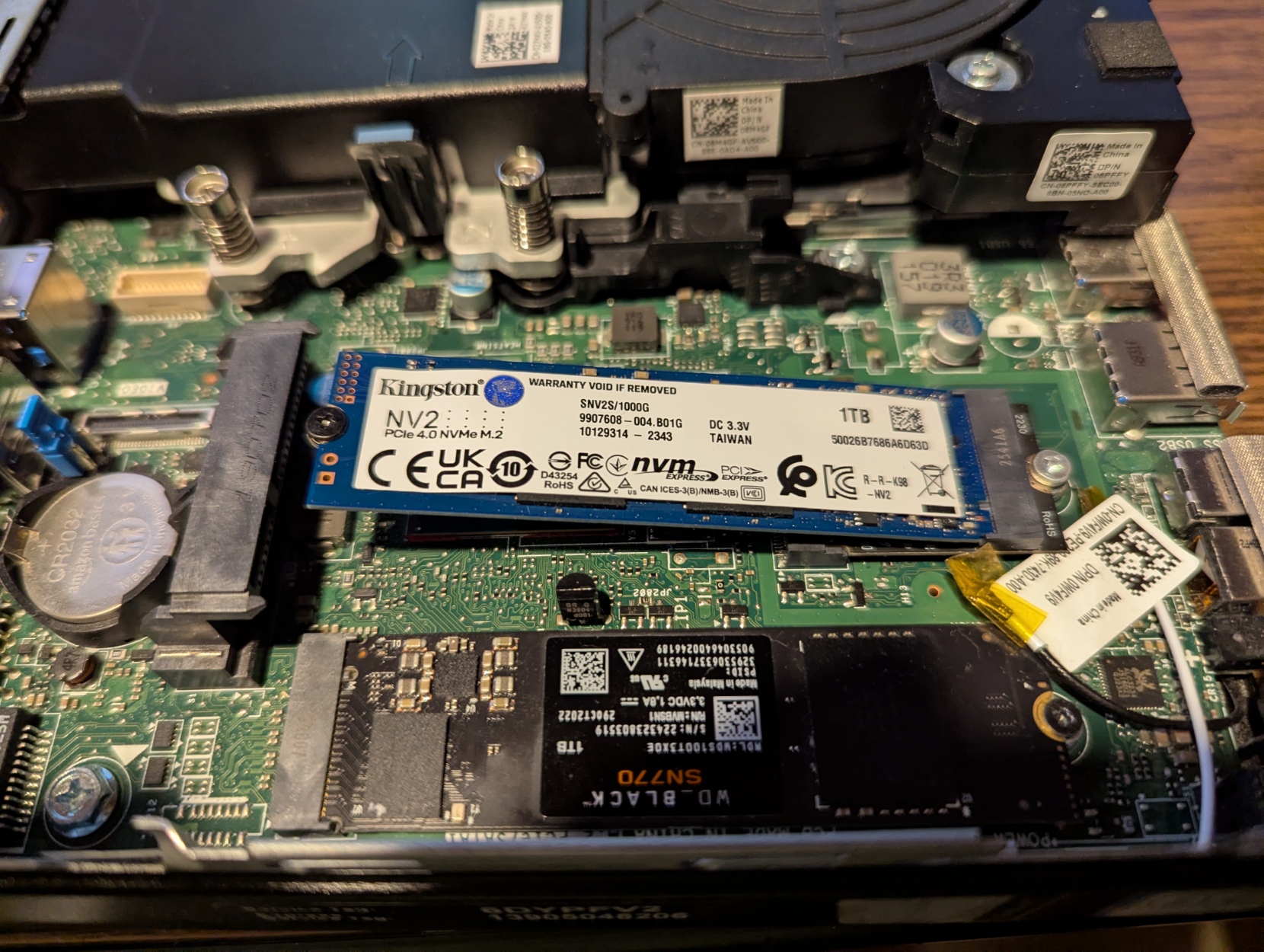 Two M.2 SSDs, one in a normal M key slot, the other at an angle on an A/E key to M key adapter